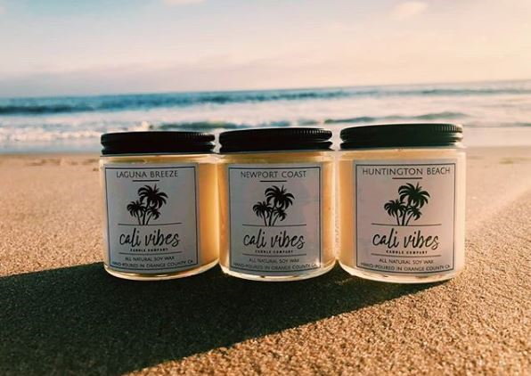 A picture of candle jars on a beach