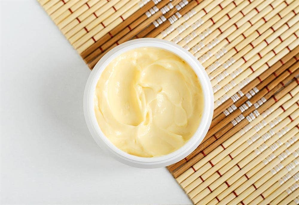 A picture of a container filled with body butter