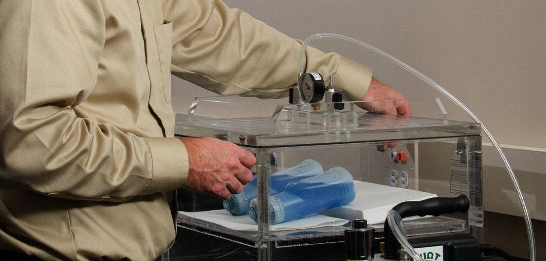 Person testing two bottles of cleaning products for quality.