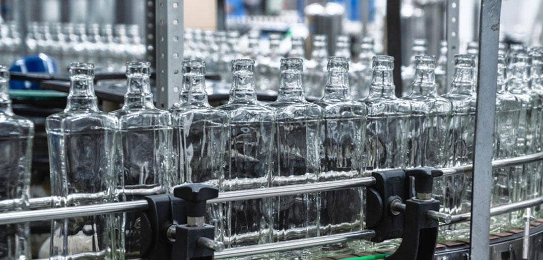 Clear glass bottles on manufacturing line