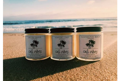 A picture of candle jars on a beach