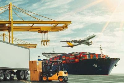 Shipping yard with container ship and truck with plane flying over