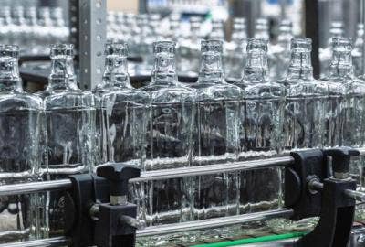 Image of clear glass bottles on manufacturing line