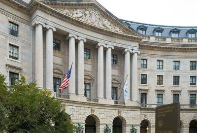 Government building with American flag and columns