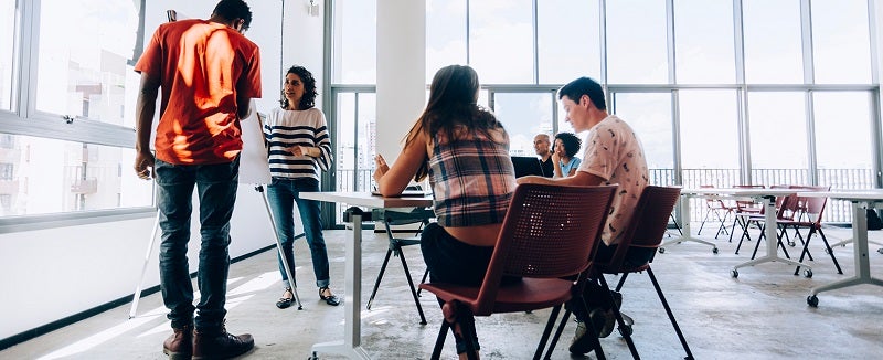 People sitting and standing around a table