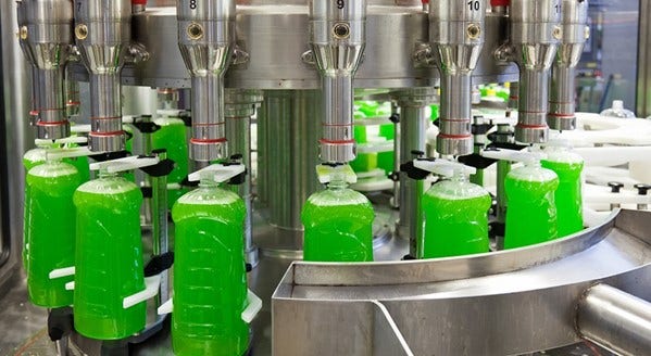 Dish soap bottles being filled on production line